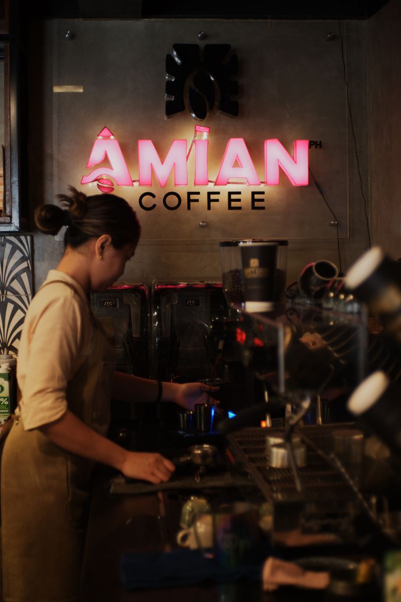 A barista pulling a shot of espresso behind Brew Lane's counter